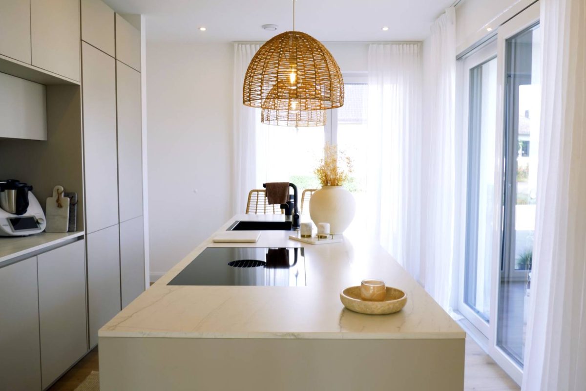 a kitchen with a light from a ceiling