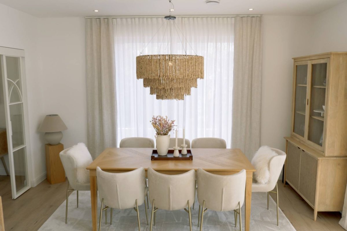 a dining table with chairs and a chandelier