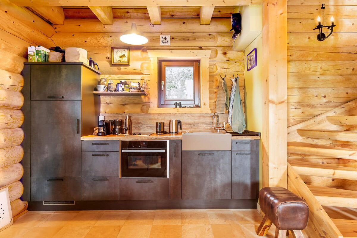 LéonWood Blockhaus Husky dunkle Küche mit Holzwand und Holzdecke